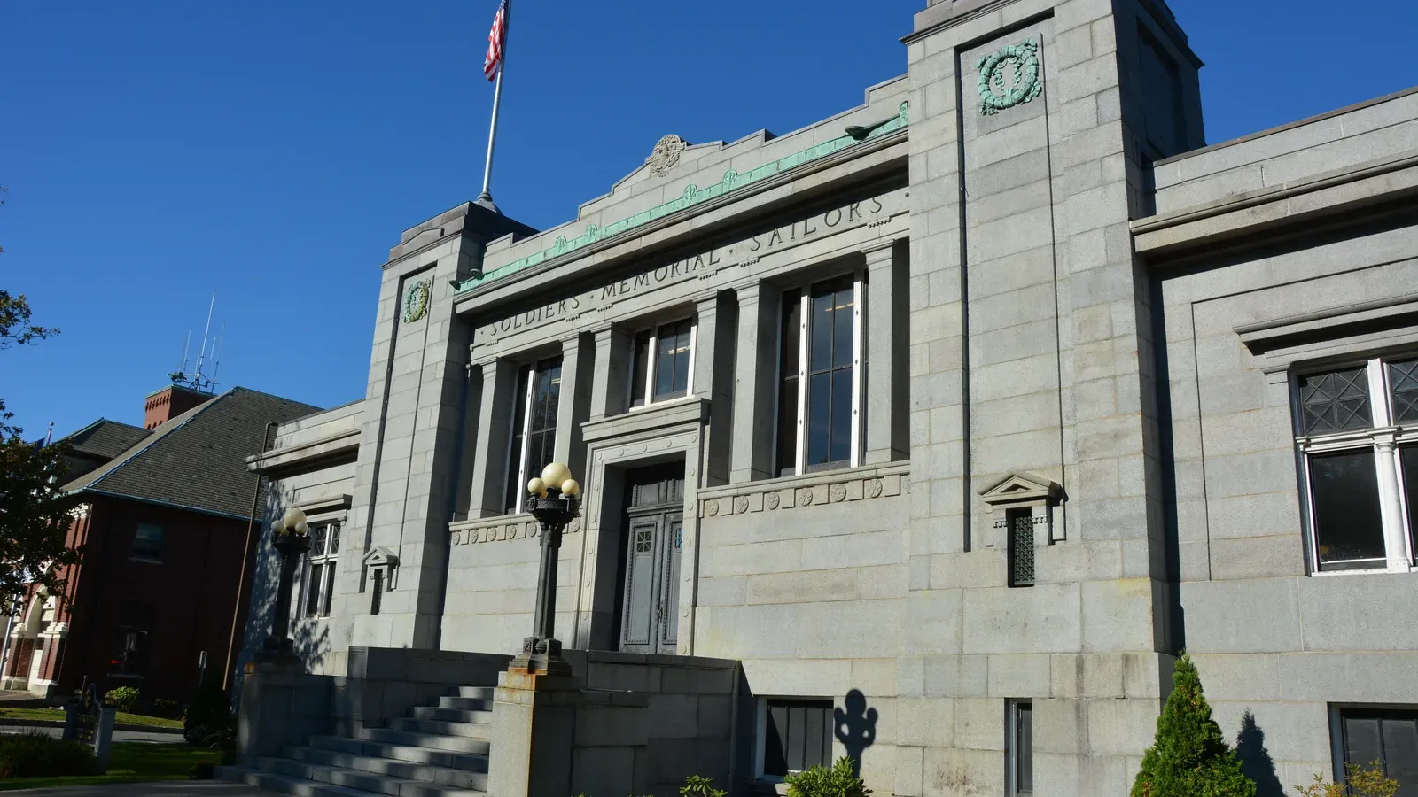 Melrose Memorial Hall, a granite Neoclassical civic building with a clock, Melrose, Massachusetts